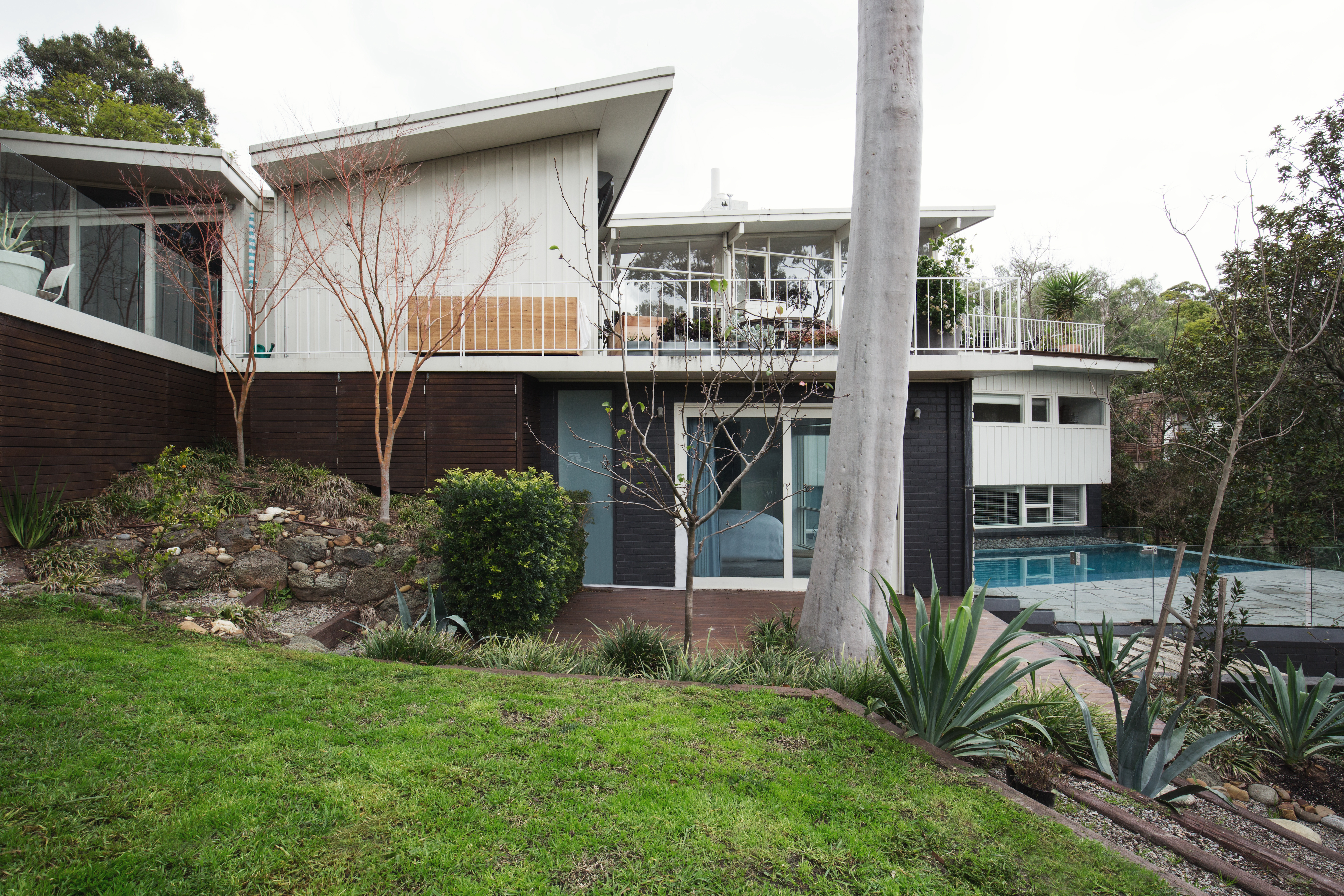 Mid century modern home with a pool and a butterfly roof